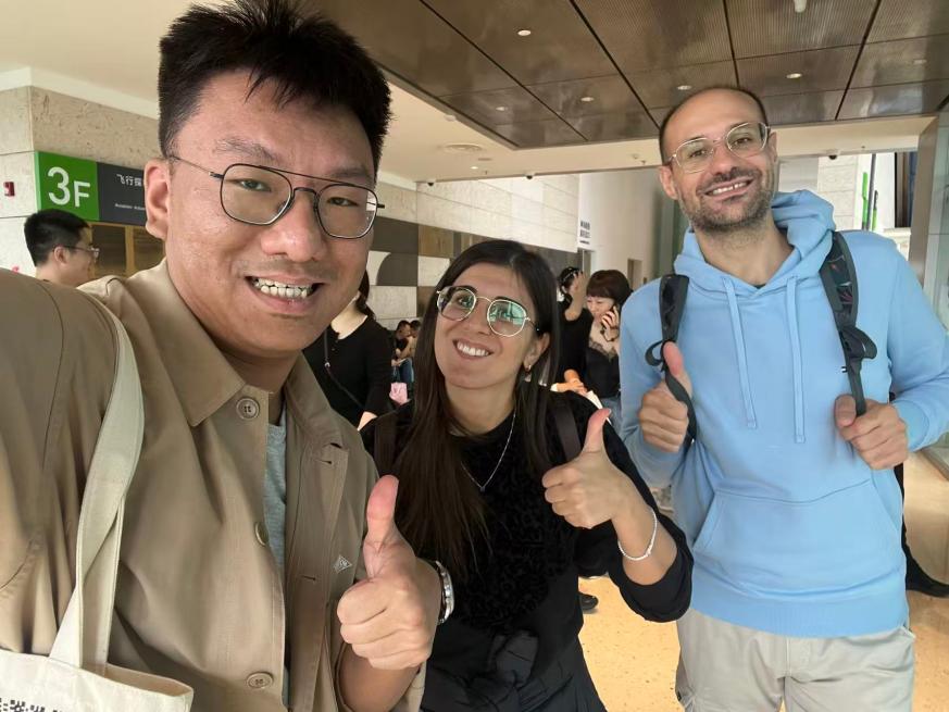 William Shan welcoming two international guests during their Shanghai visit