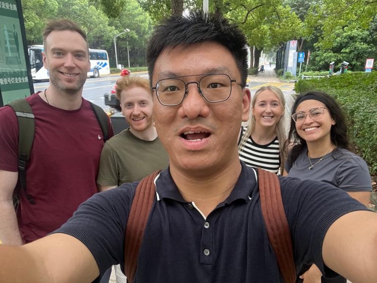 William Shan with a group of guests outdoors in Shanghai